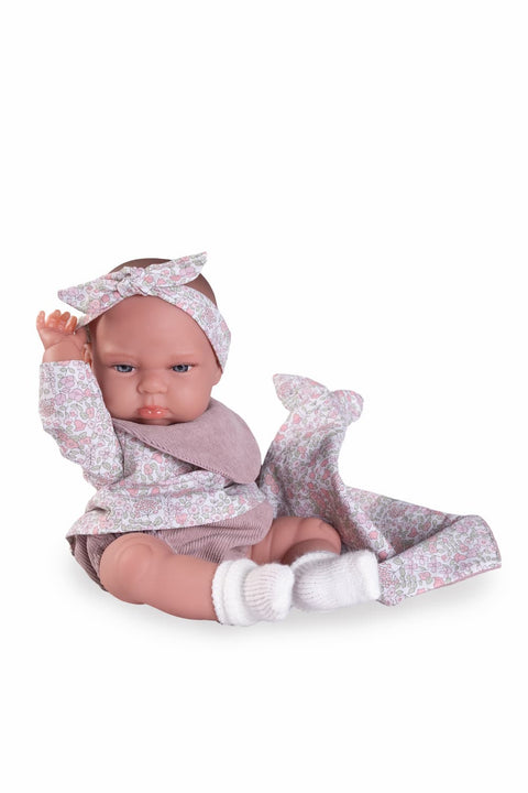 Muñeca Tufi con babero y lazo floral

