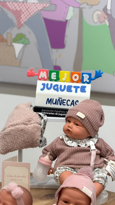 Reborn Baby Love con portabebé junto al trofeo Mejor Juguete 2026, categoría Muñecas, de la Asociación Española de Fabricantes de Juguetes